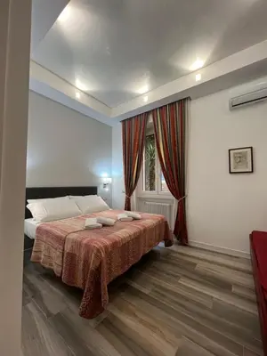 a bedroom with a bed and a window at ARTPA Rome Apartments in Rome