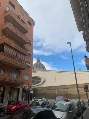 a parking lot with cars parked in front of a building at ARTPA Rome Apartments in Rome
