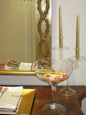 a wooden table with a glass bowl and a mirror at La Rotella Nel Sacco in Rome