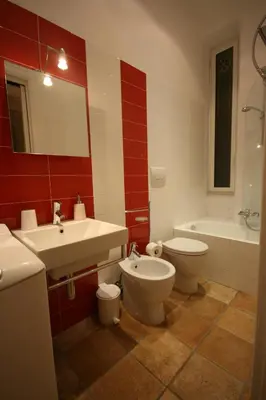 a bathroom with a sink and a toilet and a tub at La Rotella Nel Sacco in Rome