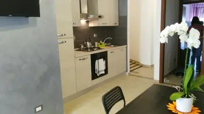 a kitchen with a table and a stove top oven at Marco E Laura Affittacamere al Vaticano in Rome