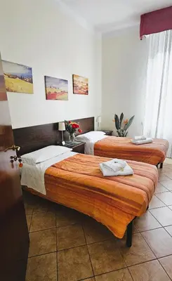 a room with two beds in a room at Titina B&B in Rome