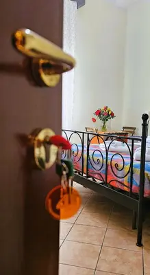 a toy is standing in front of a bed at Titina B&B in Rome