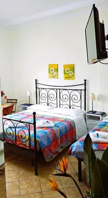 a bedroom with a bed and a flat screen tv at Titina B&B in Rome