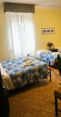 a bedroom with two beds and a window at Titina B&B in Rome