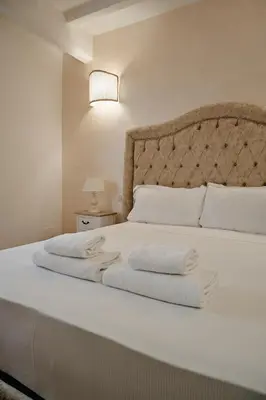 a bedroom with a white bed with towels on it at Cozy Studio Parlamento in Rome