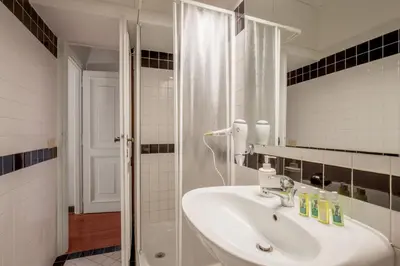 a bathroom with a sink and a shower at Cozy Studio Parlamento in Rome