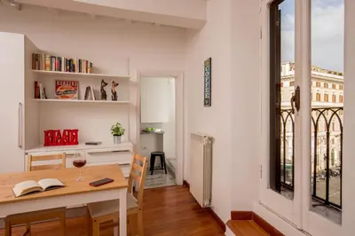 a kitchen and dining room with a table and a window at Cozy Studio Parlamento in Rome