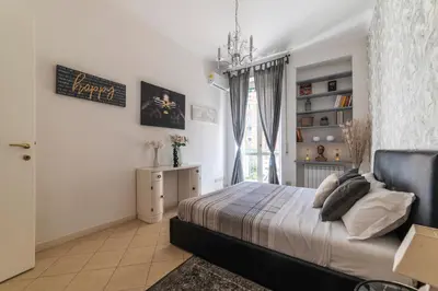 a bedroom with a bed and a window at Vatican Corner Family Apartment in Rome