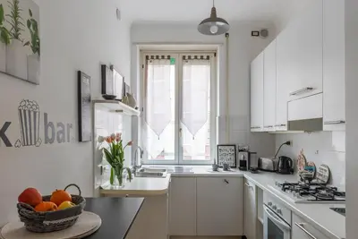 a kitchen with a bowl of fruit on a table at Vatican Corner Family Apartment in Rome