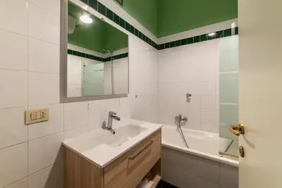 a bathroom with a sink and a tub at Vatican Corner Family Apartment in Rome