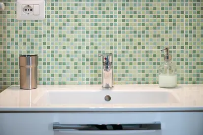 a sink in a bathroom with green tiles at Dream Holiday Home in Rome