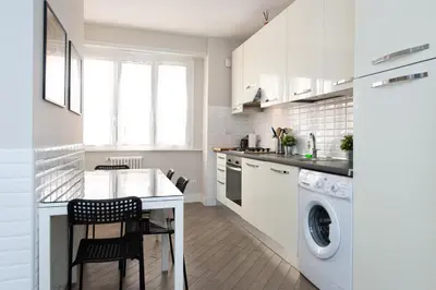 a white kitchen with a washer and dryer at Dream Holiday Home in Rome