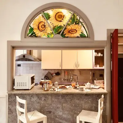 a kitchen with a window with sunflowers on it at Delicious House in Rome