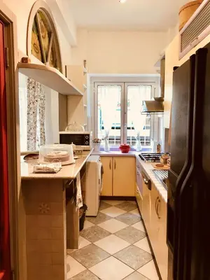 a kitchen with a sink and a stove top oven at Delicious House in Rome