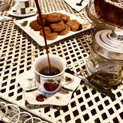 a cup of coffee and cookies on a table at Delicious House in Rome