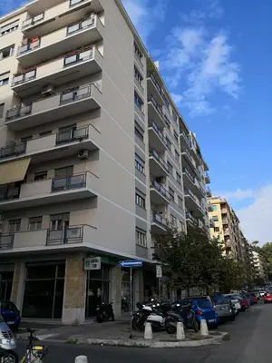 a tall building with cars parked in front of it at Delicious House in Rome