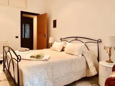 a bedroom with a large bed with white sheets at Delicious House in Rome