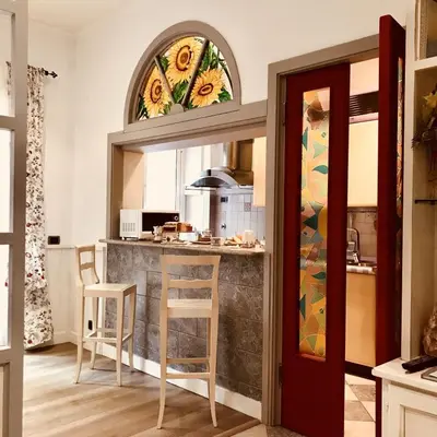 a kitchen with a bar with a stained glass window at Delicious House in Rome