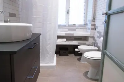 a bathroom with a sink and a toilet and a window at Miani House in Rome