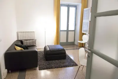 a living room with a couch and a suitcase at Miani House in Rome
