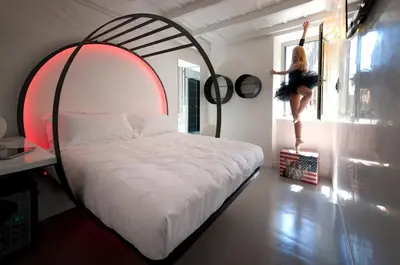 a woman is standing on a bed in a room at iRooms - Spanish Steps in Rome