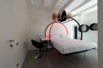 a person jumping over a bed in a room at iRooms - Spanish Steps in Rome