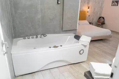 a white bath tub in a room with a bed at iRooms - Spanish Steps in Rome