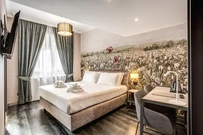 a hotel room with a bed and a painting on the wall at PAX hotel in Rome
