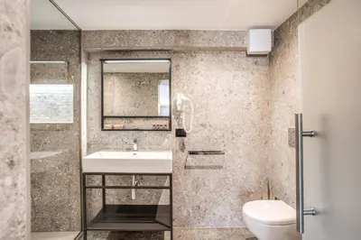 a bathroom with a sink and a toilet at PAX hotel in Rome
