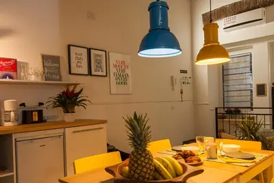 a kitchen with a table with a pineapple on it at The yellow house in Rome