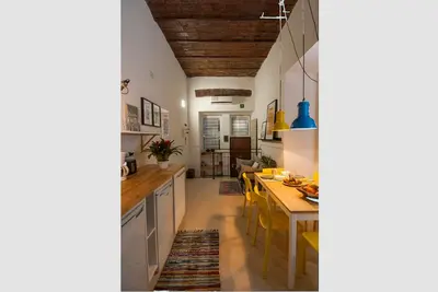 a kitchen with a table and a dining room at The yellow house in Rome