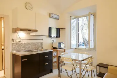 a kitchen with a table and chairs in a room at Vatican House in Rome