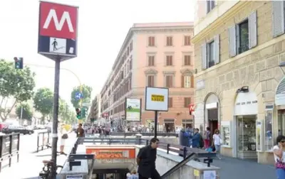a group of people walking down a city street at Vatican House in Rome