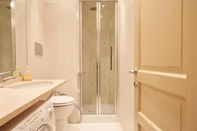 a bathroom with a shower and a toilet and a sink at Vatican House in Rome