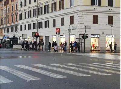 a group of people walking on a city street at Vatican House in Rome