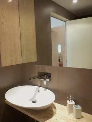 a bathroom with a white sink and a mirror at WellnessINNrome shortlet in Rome