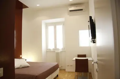 a bedroom with a bed and a window at WellnessINNrome shortlet in Rome