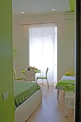a room with two beds and a table in a room at WellnessINNrome shortlet in Rome