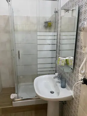 a bathroom with a sink and a shower at Juna's guest house in Rome