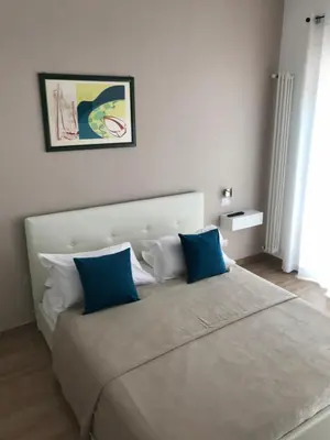 a bedroom with a large bed with blue pillows at Juna's guest house in Rome