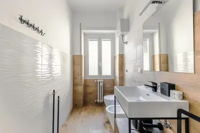 a bathroom with a white sink and a toilet at Apartment Costanza in Rome in Rome