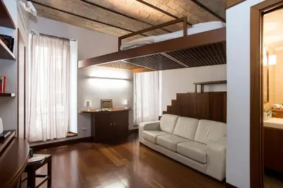 a living room with a white couch in a room at Trevi Fountain - Lovely Loft Apartment in Rome
