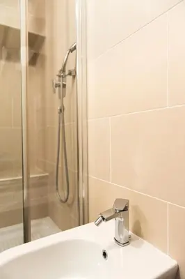 a bathroom with a shower and a sink at Trevi Fountain - Lovely Loft Apartment in Rome