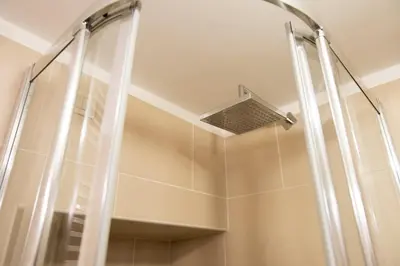 a shower with a shower head in a bathroom at Trevi Fountain - Lovely Loft Apartment in Rome
