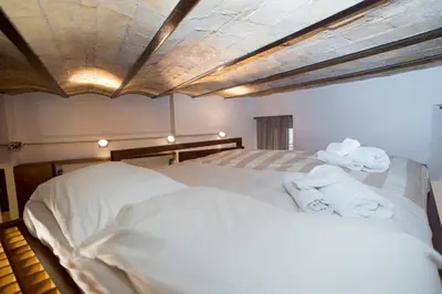 a bedroom with a bed with towels on it at Trevi Fountain - Lovely Loft Apartment in Rome