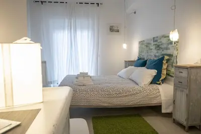 a bedroom with a bed with blue and white pillows at Tempo Lento in Rome