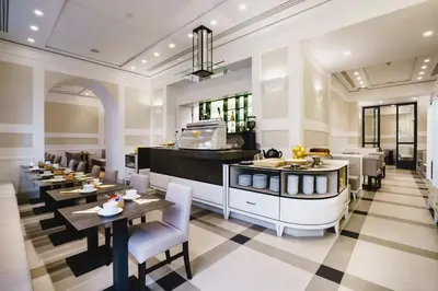 a restaurant with tables and chairs and a counter at Hotel Smeraldo in Rome