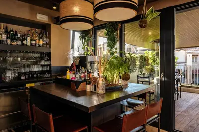a bar in a restaurant with a table and chairs at Hotel Smeraldo in Rome