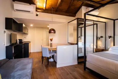 a bedroom with a bed and a desk and a table at Hotel Smeraldo in Rome